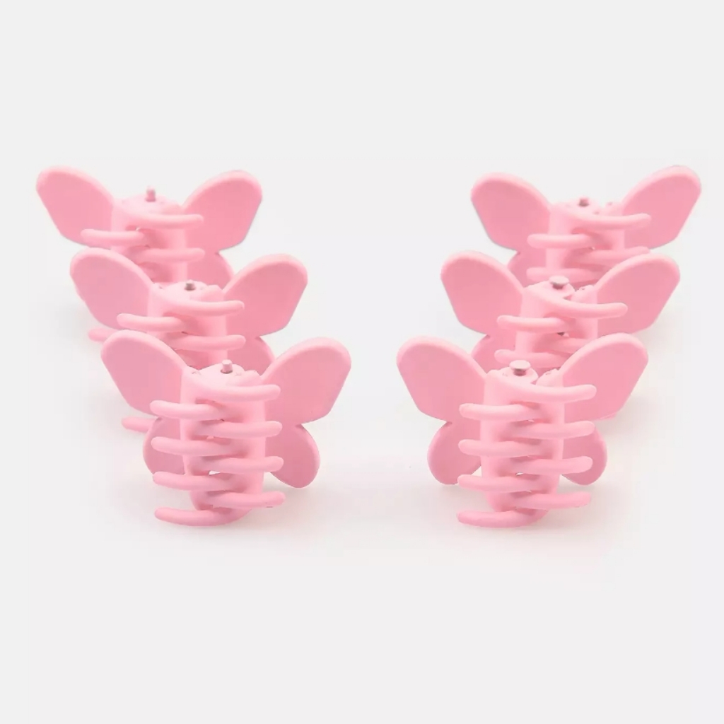 Two sets of five pink moulded butterfly hair clips on a white background